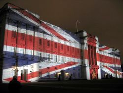 Buckingham Palace with the Union Jack projected onto it for Christmas Eve 2003